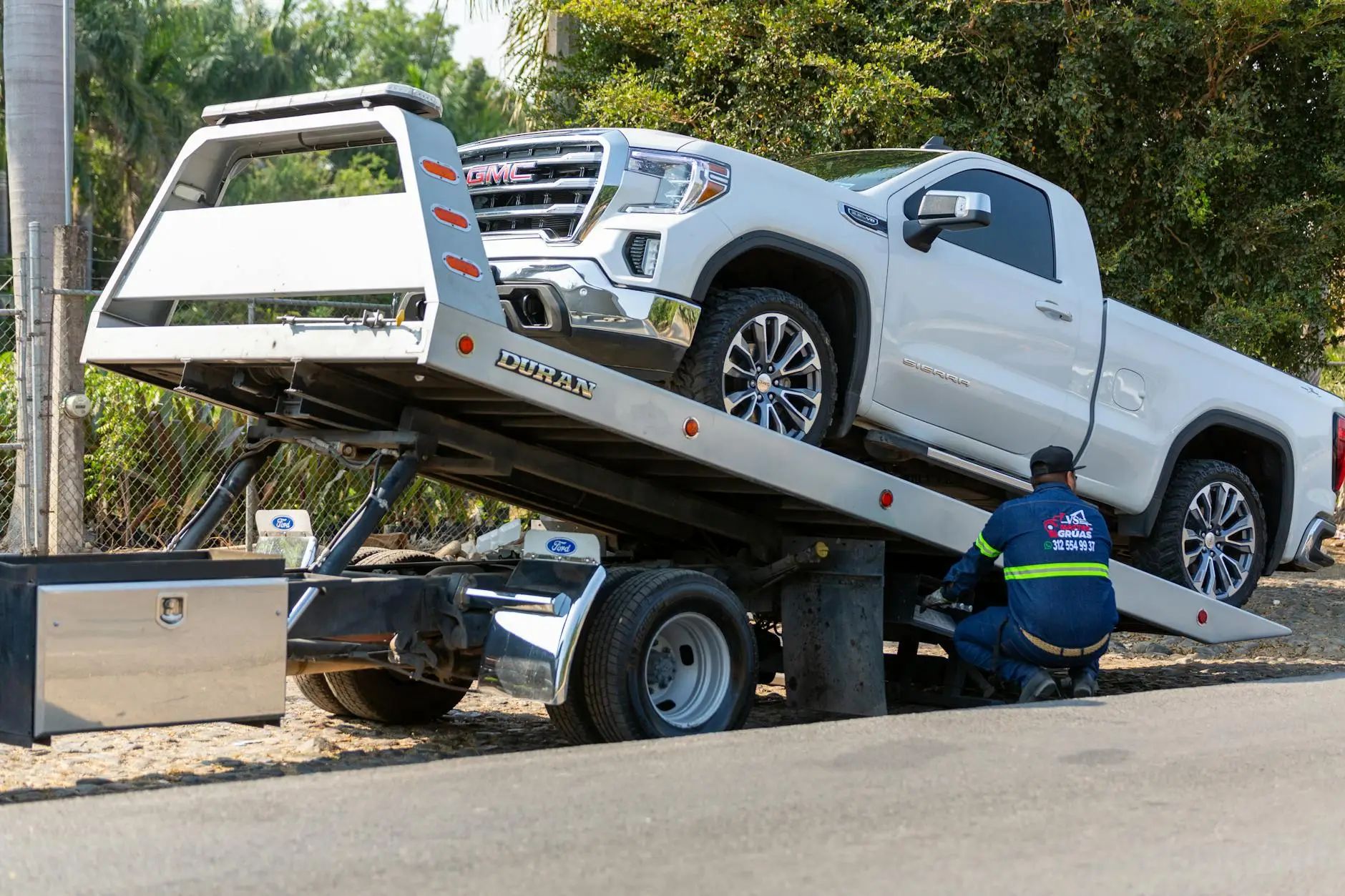 A DAD'S TOWING SERVICE LLC truck arriving at a roadside assistance call in a Westminster residential neighborhood.